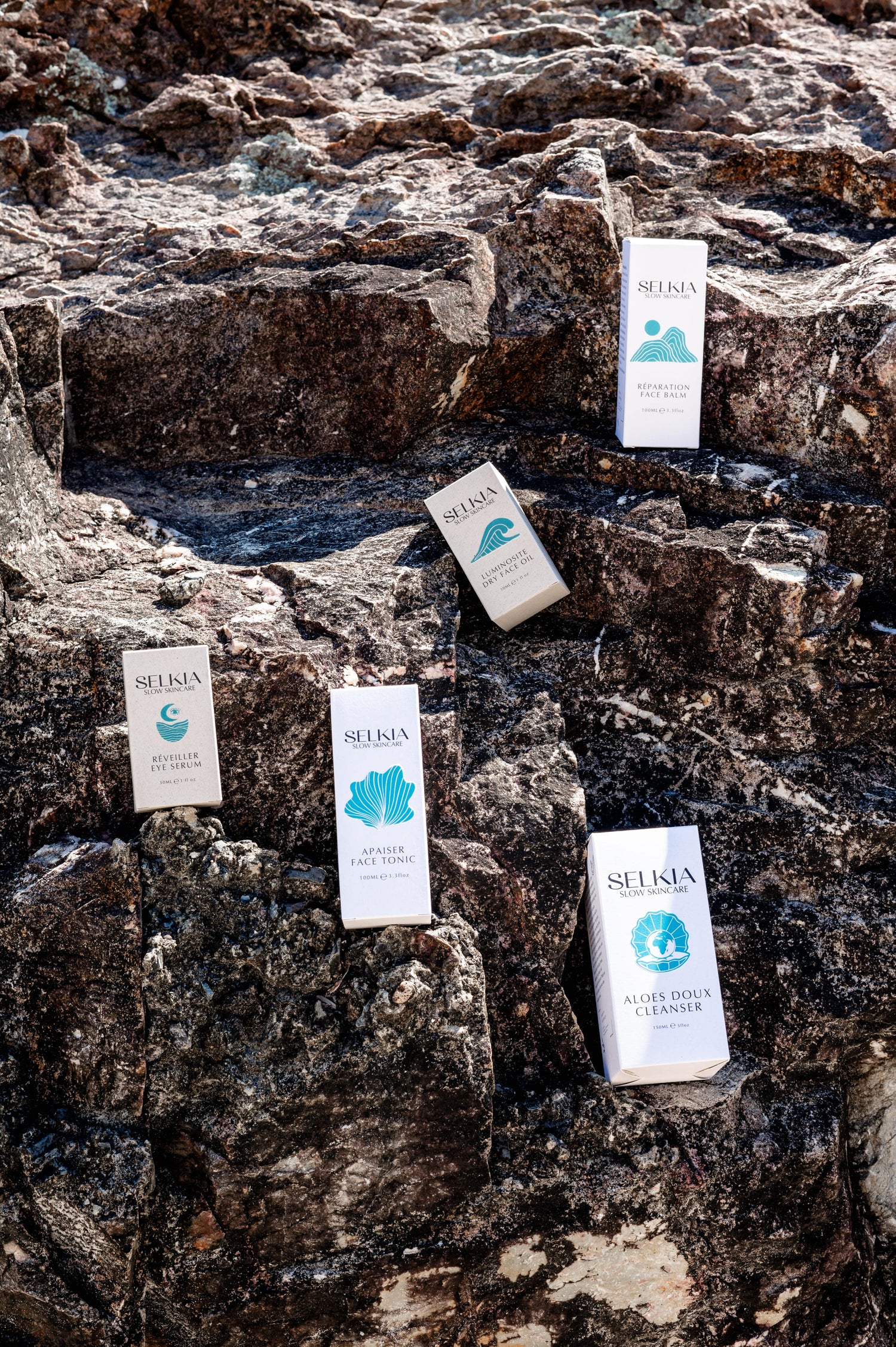 Selkia facial product range on rock background