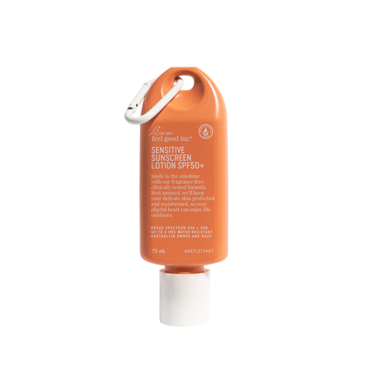 Orange sunscreen lotion bottle with carabiner on a white background